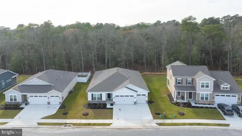 a aerial view of a house with swimming pool and trees