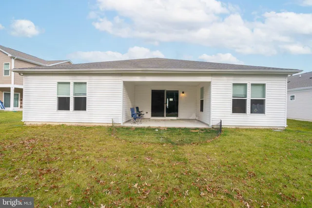 a backyard of a house with table and chairs