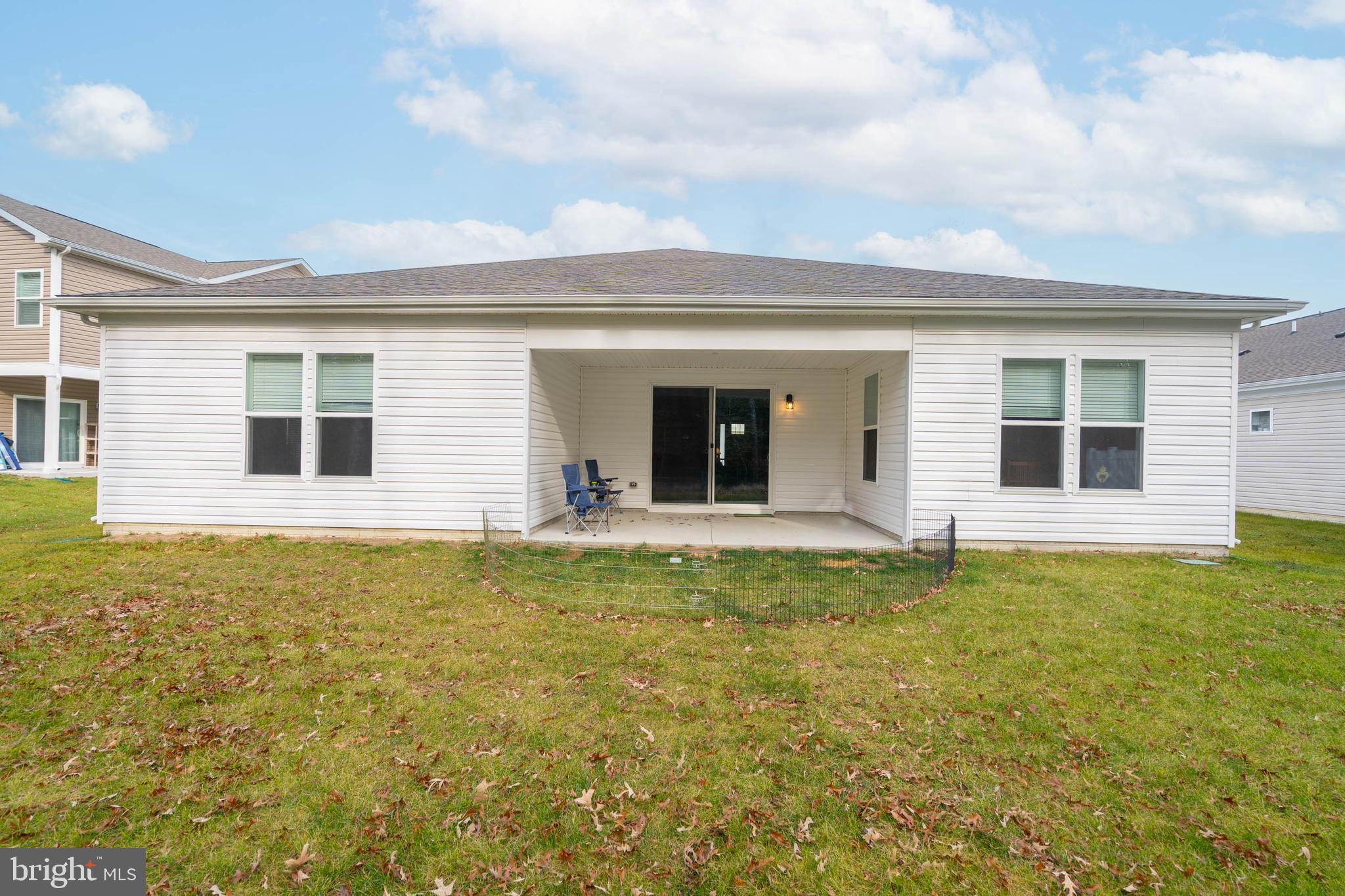 34084 Skyflower Loop Lewes, DE 19958 - Photo 17 of 50 a view of a house with a backyard and a chair