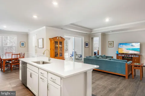 a kitchen with sink refrigerator and dining table