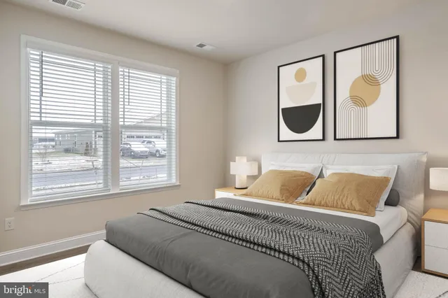 a bedroom with a bed and painting on the wall