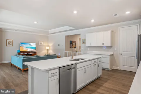 a kitchen with sink refrigerator and dining table