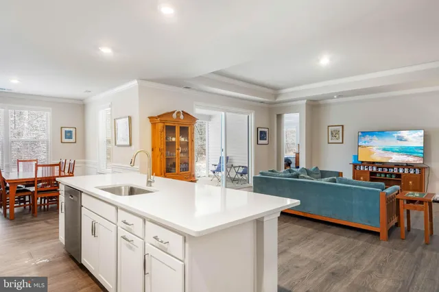 a dining room with furniture large window and wooden floor