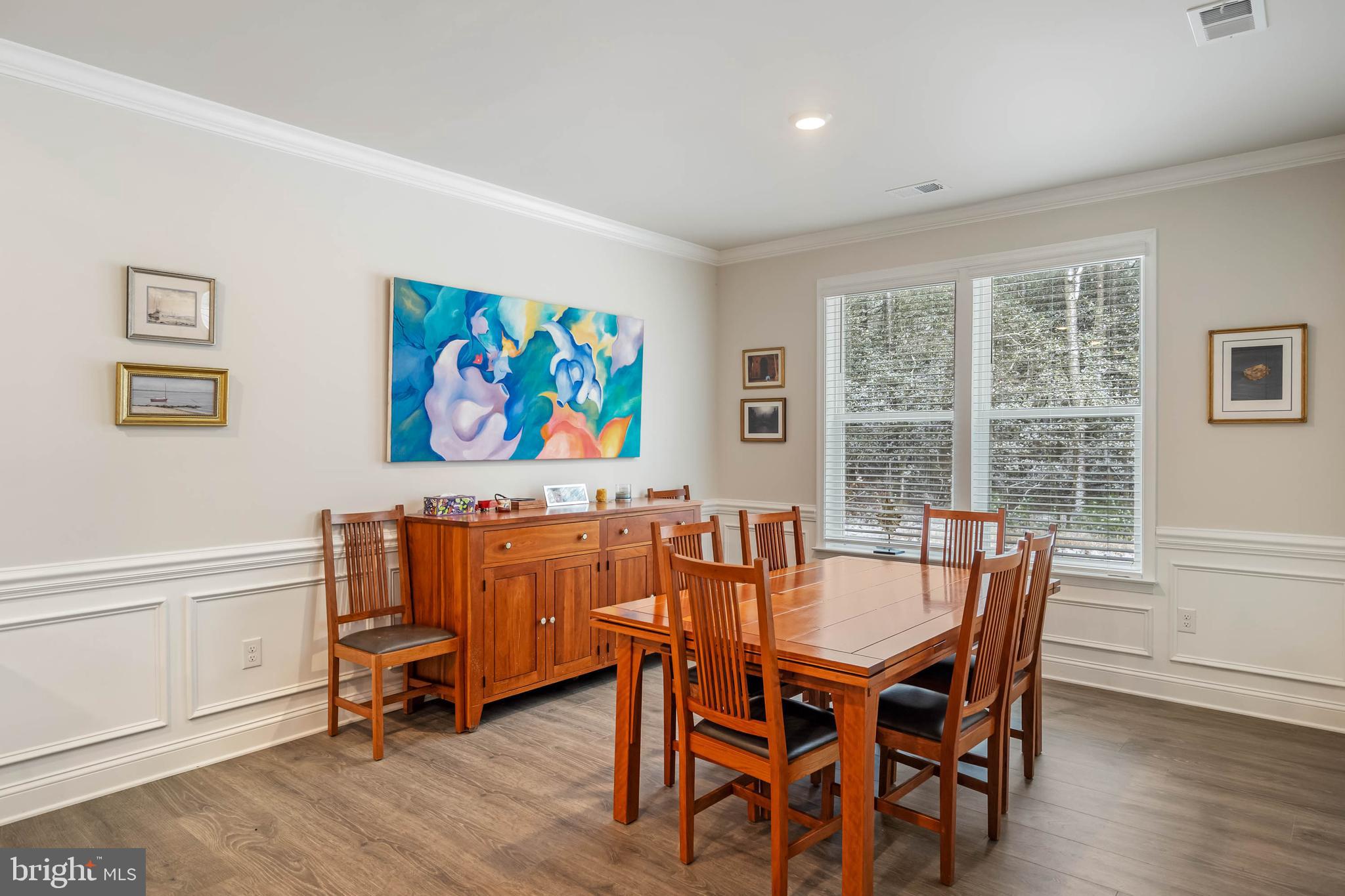 34084 Skyflower Loop Lewes, DE 19958 - Photo 34 of 50 a dining room with furniture large window and wooden floor
