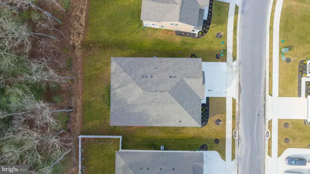 aerial view of a house with a yard