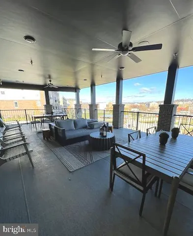 a living room with lots of furniture and a large window