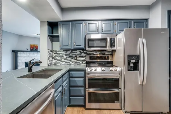 a kitchen with a sink stove and refrigerator