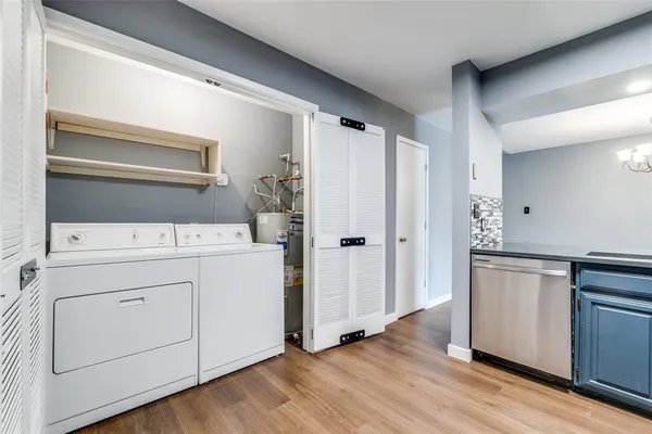 a utility room with cabinets washer and dryer