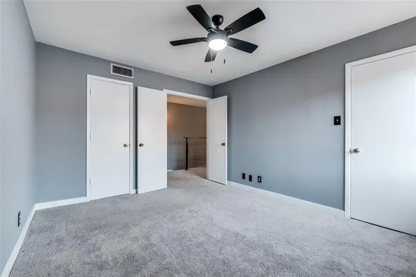 a view of an empty room and a ceiling fan