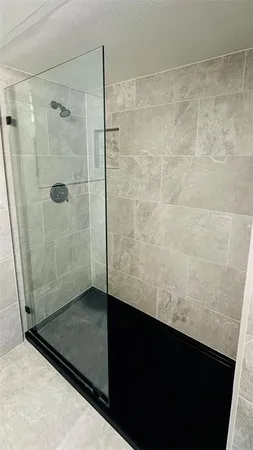 a bathroom with a glass shower door