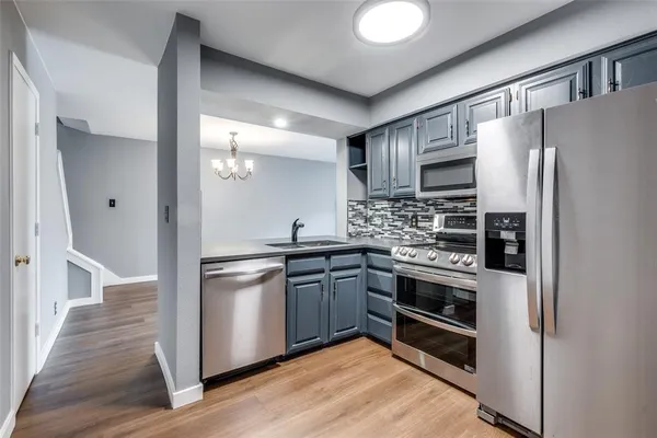 a kitchen with stainless steel appliances and wooden cabinets