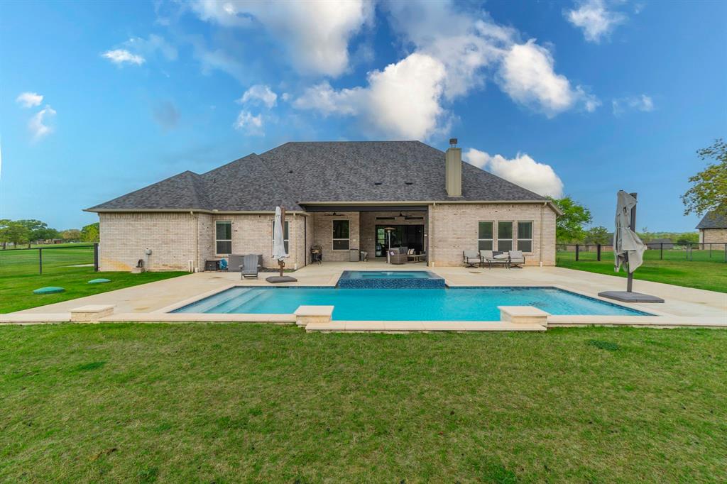 150 Las Brisas Drive Decatur, TX 76234 - Photo 30 of 32 Rear view of property with a fenced backyard, a patio area, brick siding, a chimney, and a pool with connected hot tub