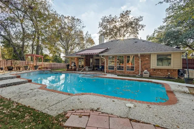 a view of a house with swimming pool and sitting area