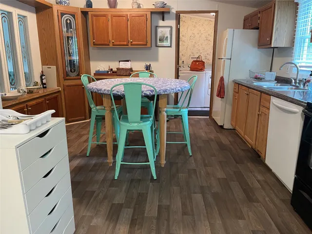 a dining room with a wooden table and chairs
