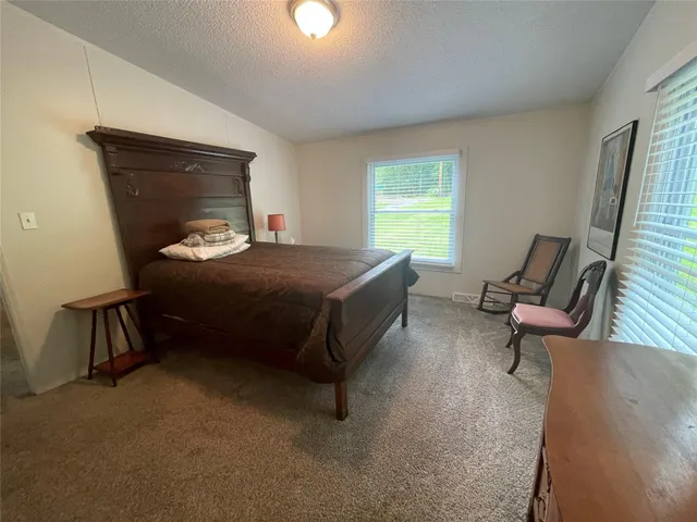 a bedroom with a bed and a mirror