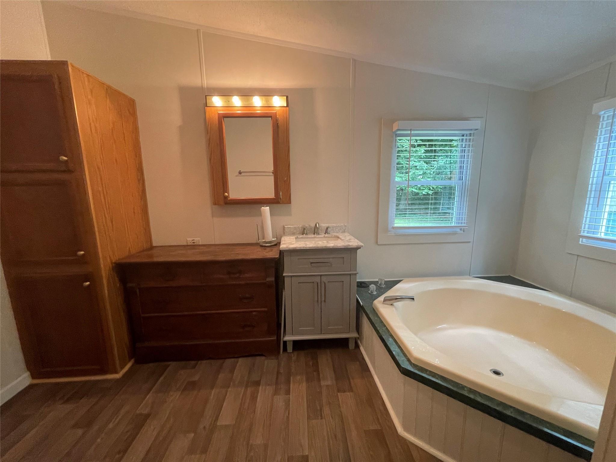 4261 State Rt 17B Callicoon, NY 12723 - Photo 28 of 37 a bathroom with a tub sink and mirror