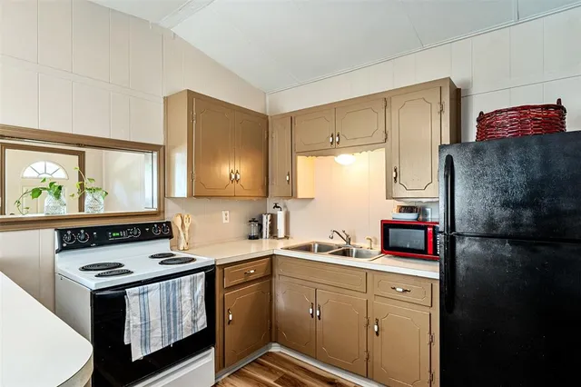 a kitchen with a sink stove and refrigerator