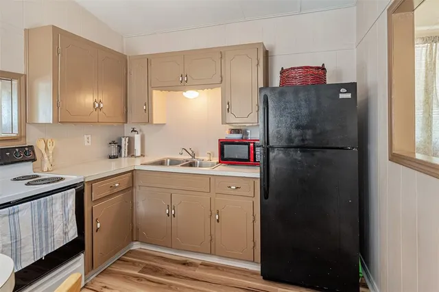 a kitchen with a refrigerator and cabinets