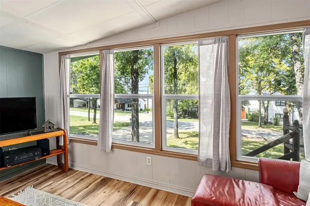 a bedroom with furniture and large windows