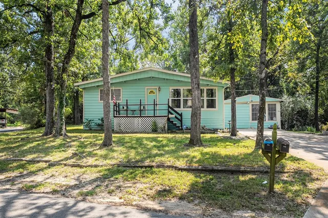a view of a house with swimming pool and sitting area