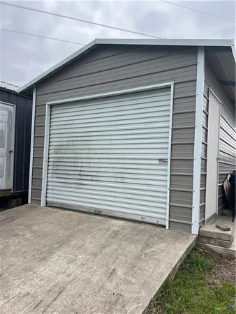 a view of a house with white door and garage