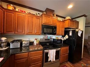 847 Hefner Lane Cuero, TX 77954 - Photo 31 of 48 a kitchen with stainless steel appliances granite countertop a refrigerator and a stove top oven
