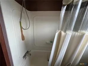 a bathroom with a shower and a toilet