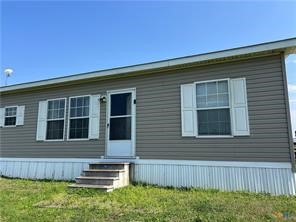 847 Hefner Lane Cuero, TX 77954 - Photo 6 of 48 a front view of a house with a yard
