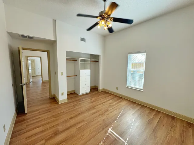 a view of empty room with wooden floor