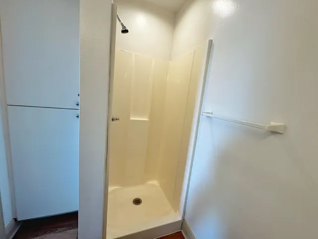 a bathroom with a glass door shower