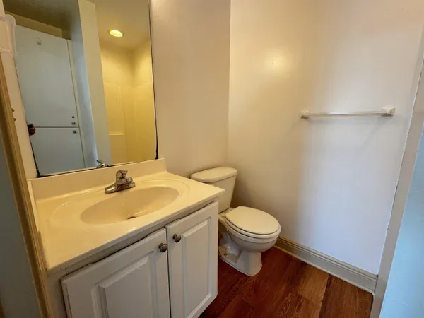 a bathroom with a sink toilet and a mirror