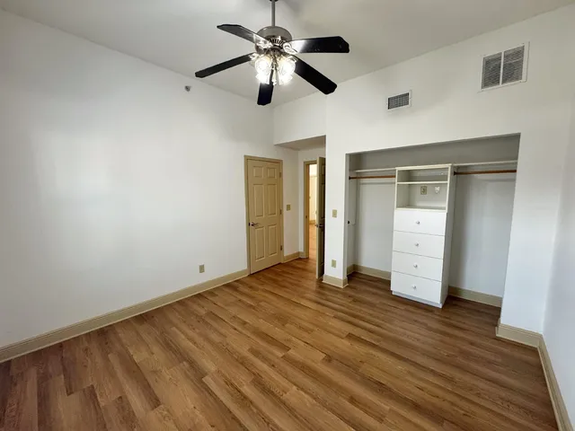 a view of empty room with wooden floor