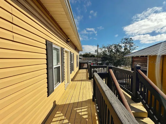a view of balcony with wooden floor and stairs