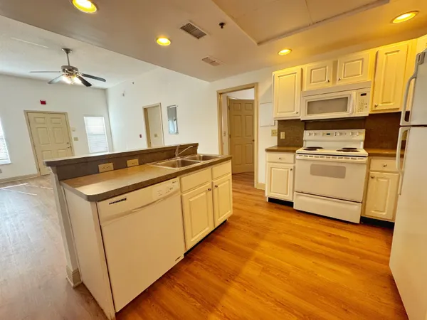a kitchen with a stove a sink and a refrigerator