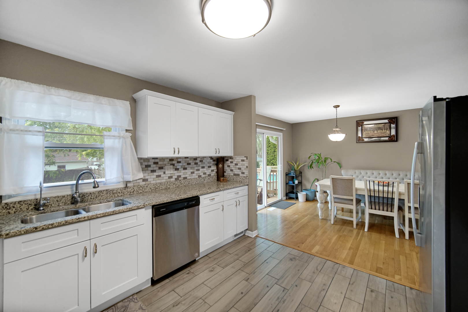 609 West Romeo Road Romeoville, IL 60446 - Photo 8 of 23 a large kitchen with a lot of counter space and wooden floor