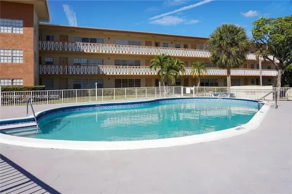 a view of a swimming pool with a lawn chairs