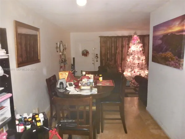 a dining room with furniture and chandelier