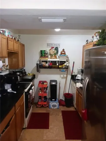 a kitchen with sink cabinets and stainless steel appliances