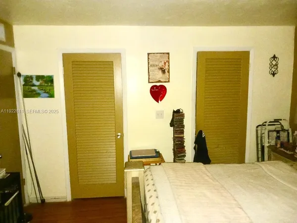 a bedroom with a bed and a dresser