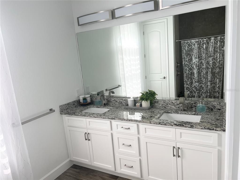 8224 Leopold Avenue North Port, FL 34287 - Photo 11 of 24 a bathroom with a granite countertop sink and a mirror