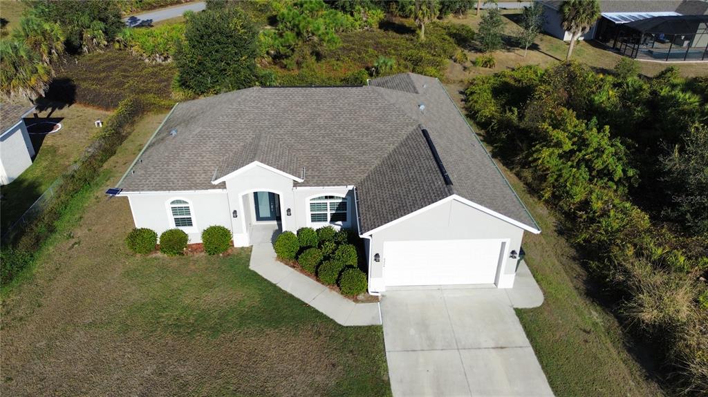 8224 Leopold Avenue North Port, FL 34287 - Photo 2 of 24 a aerial view of a house with a yard and large tree