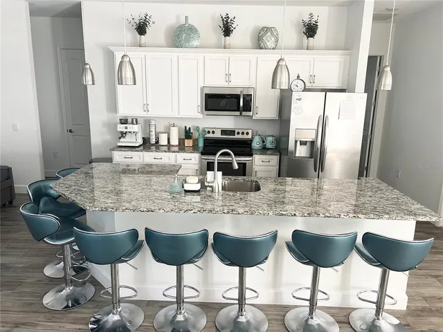 a kitchen with a dining table and chairs