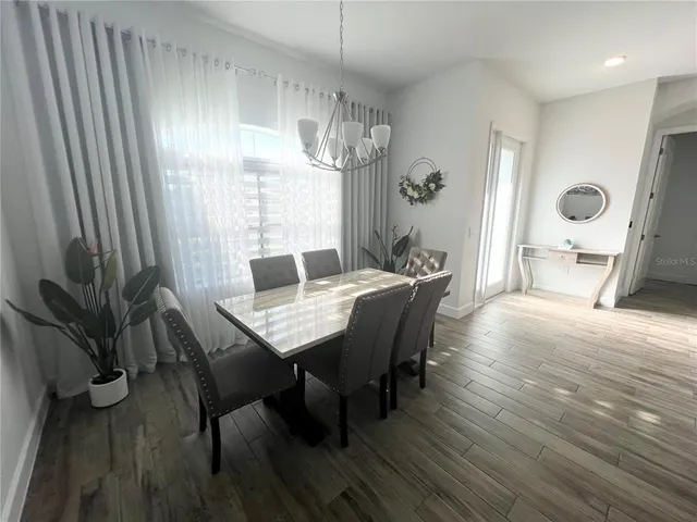a view of a dining room with furniture window and wooden floor