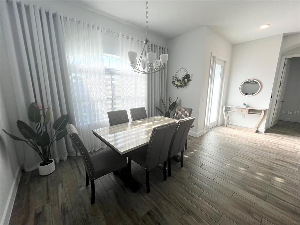 8224 Leopold Avenue North Port, FL 34287 - Photo 9 of 24 a view of a dining room with furniture window and wooden floor