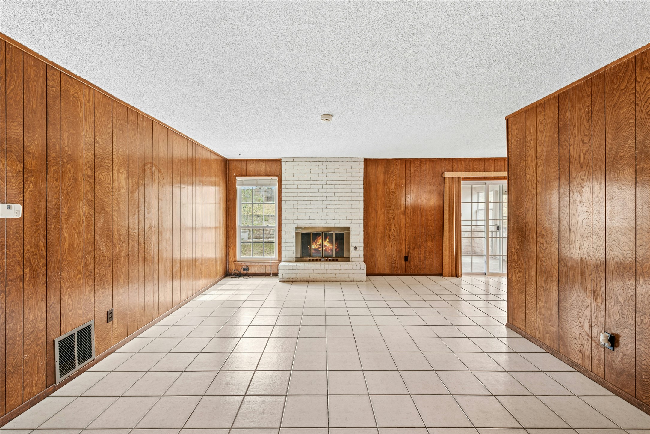 1444 Salem Meadow Circle Austin, TX 78745 - Photo 14 of 35 a view of an empty room with a fireplace and a window