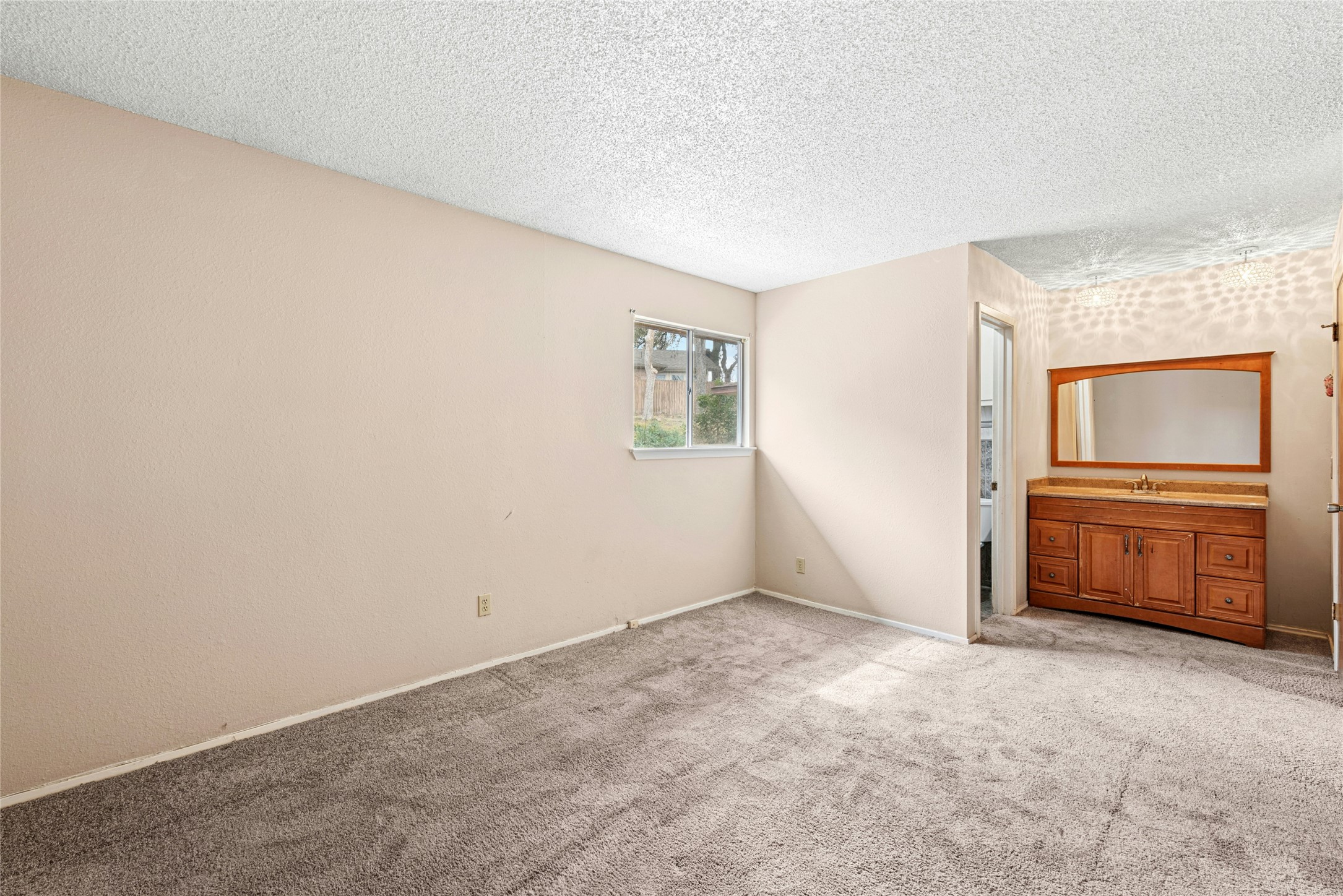1444 Salem Meadow Circle Austin, TX 78745 - Photo 17 of 35 an empty room with a cabinet and mirrors