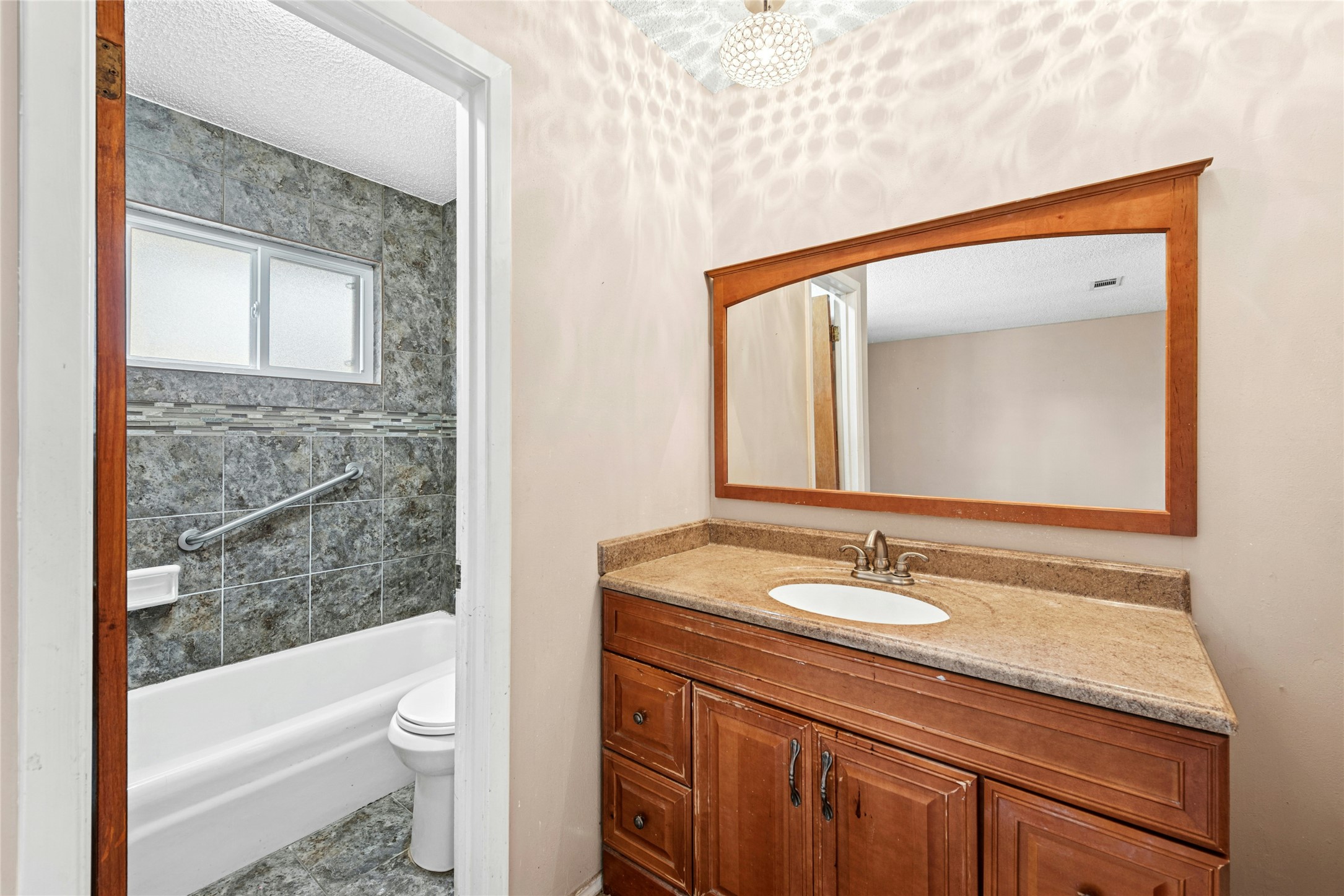 1444 Salem Meadow Circle Austin, TX 78745 - Photo 18 of 35 a bathroom with a granite countertop sink a toilet and shower