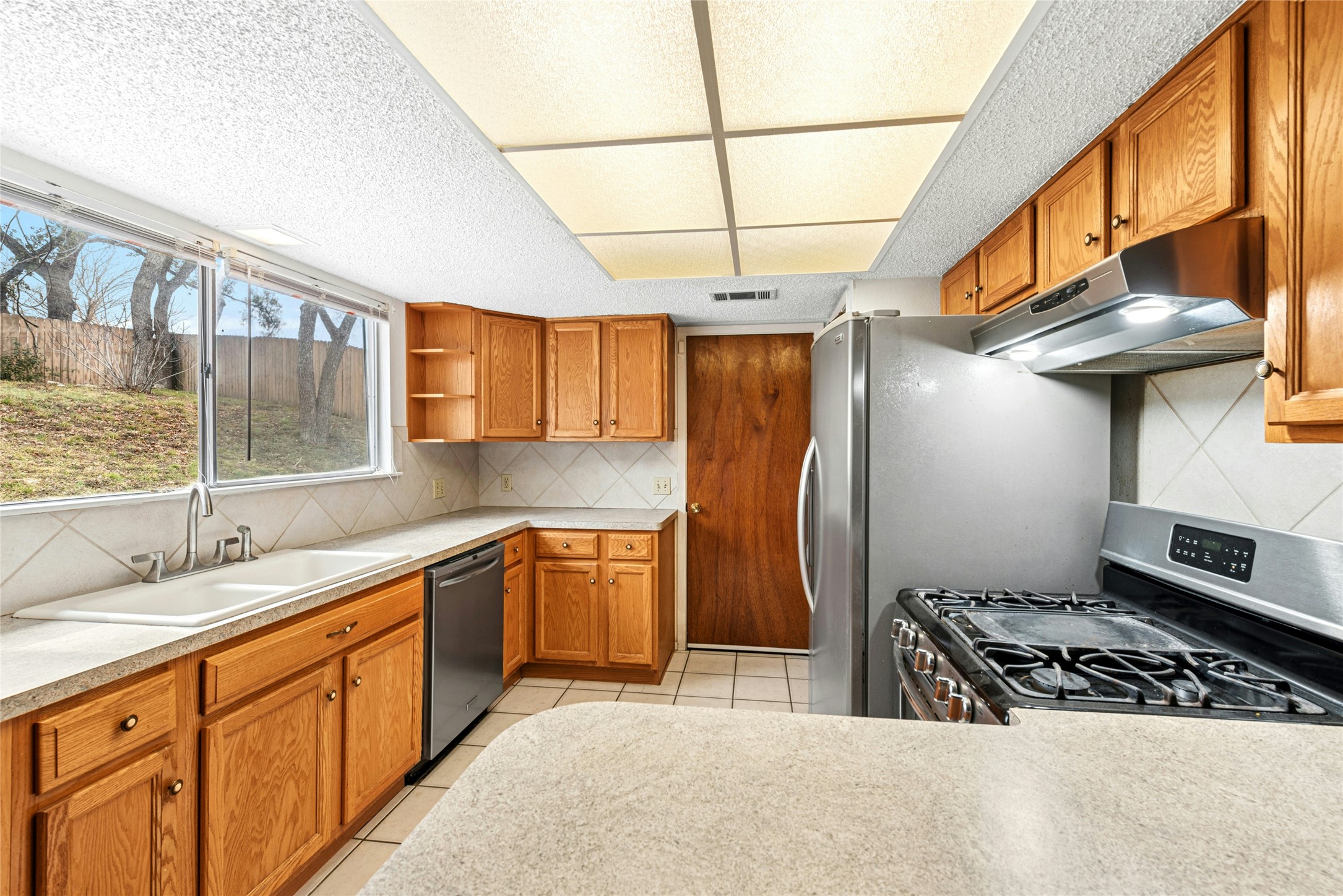 1444 Salem Meadow Circle Austin, TX 78745 - Photo 8 of 35 a kitchen with stainless steel appliances granite countertop a sink stove and refrigerator