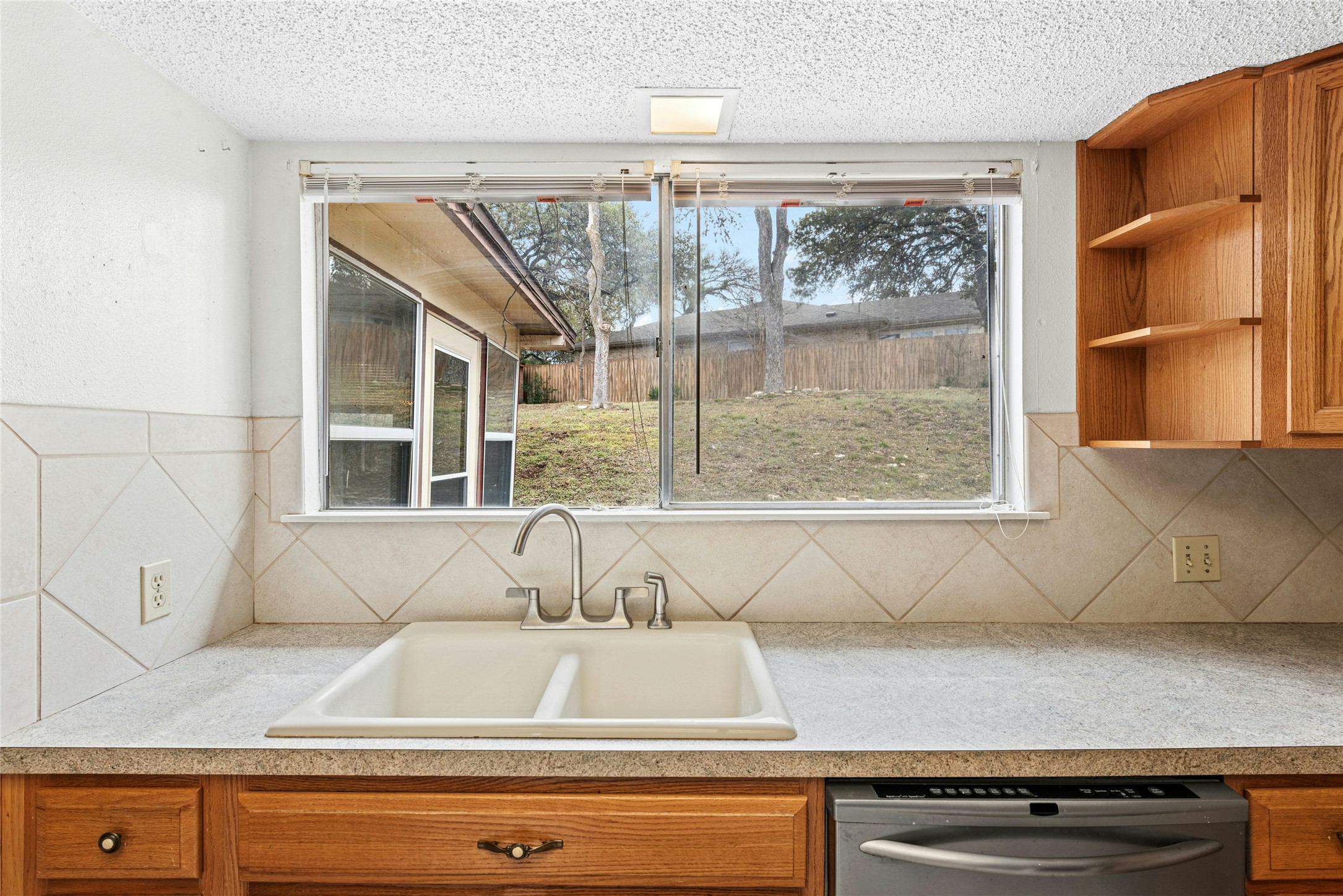 1444 Salem Meadow Circle Austin, TX 78745 - Photo 9 of 35 a kitchen with a sink and a large window