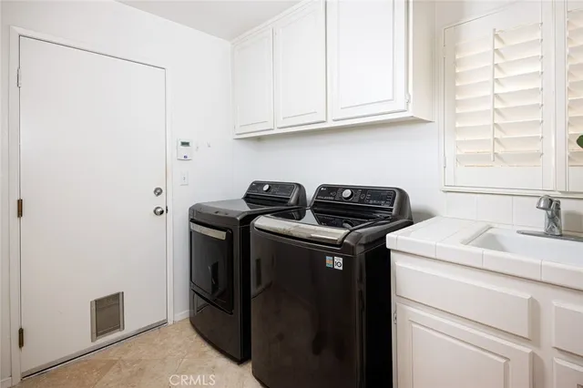a bathroom with a sink a toilet and a large mirror